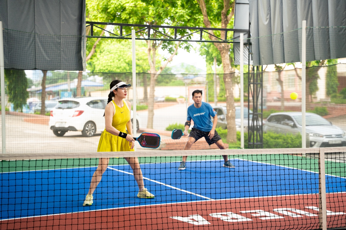 A person and person playing tennis

Description automatically generated